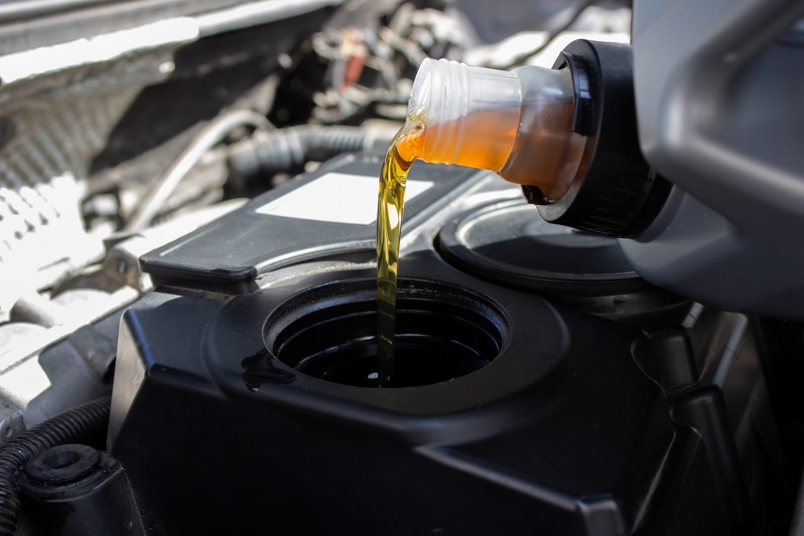 Refueling and pouring oil quality into the engine motor car Transmission and Maintenance Gear .Energy fuel concept. selective focus